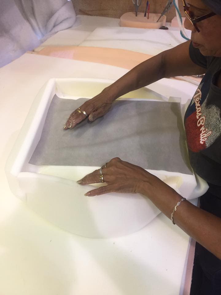 SWFT team member hand-assembling a custom foam cushion