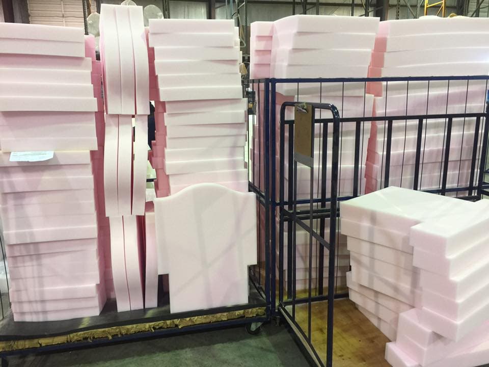 Precision-cut custom foam parts stacked on carts in the SWFT fabrication facility
